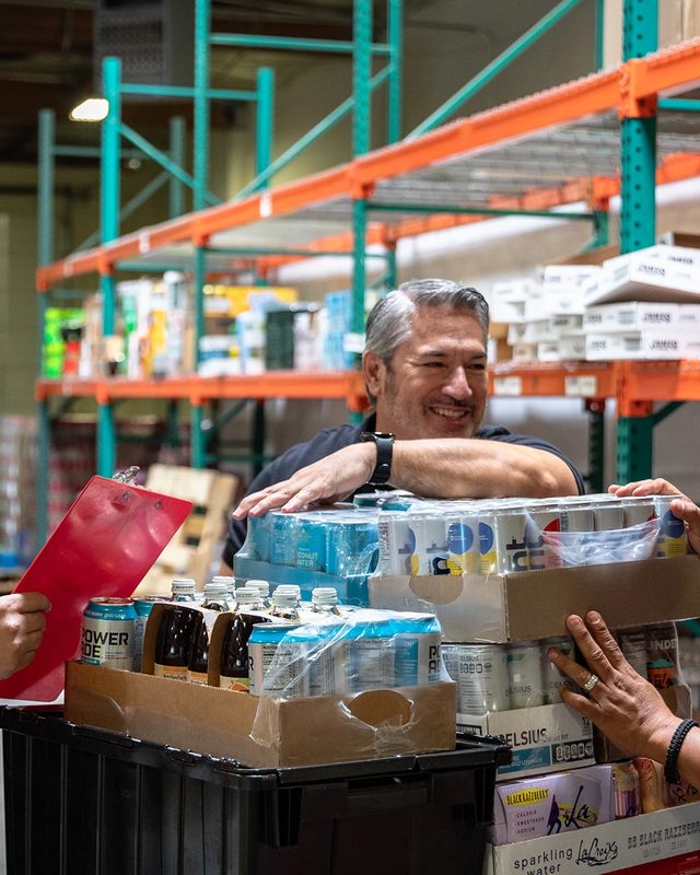Snackwise team packing cases in a warehouse